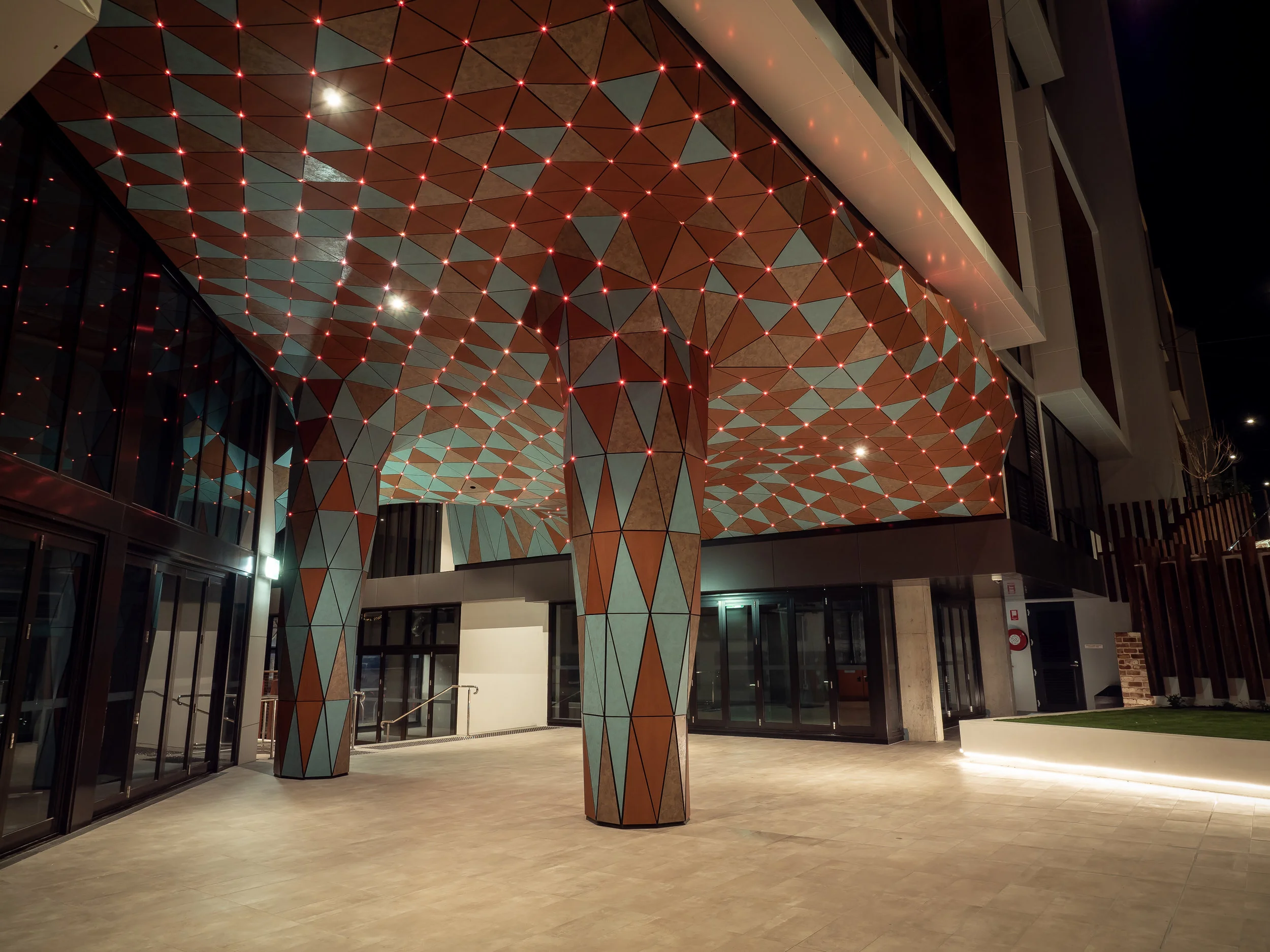 Anemoi integrated public artwork with folded illuminated surface in a Fremantle apartment entrance corridor.